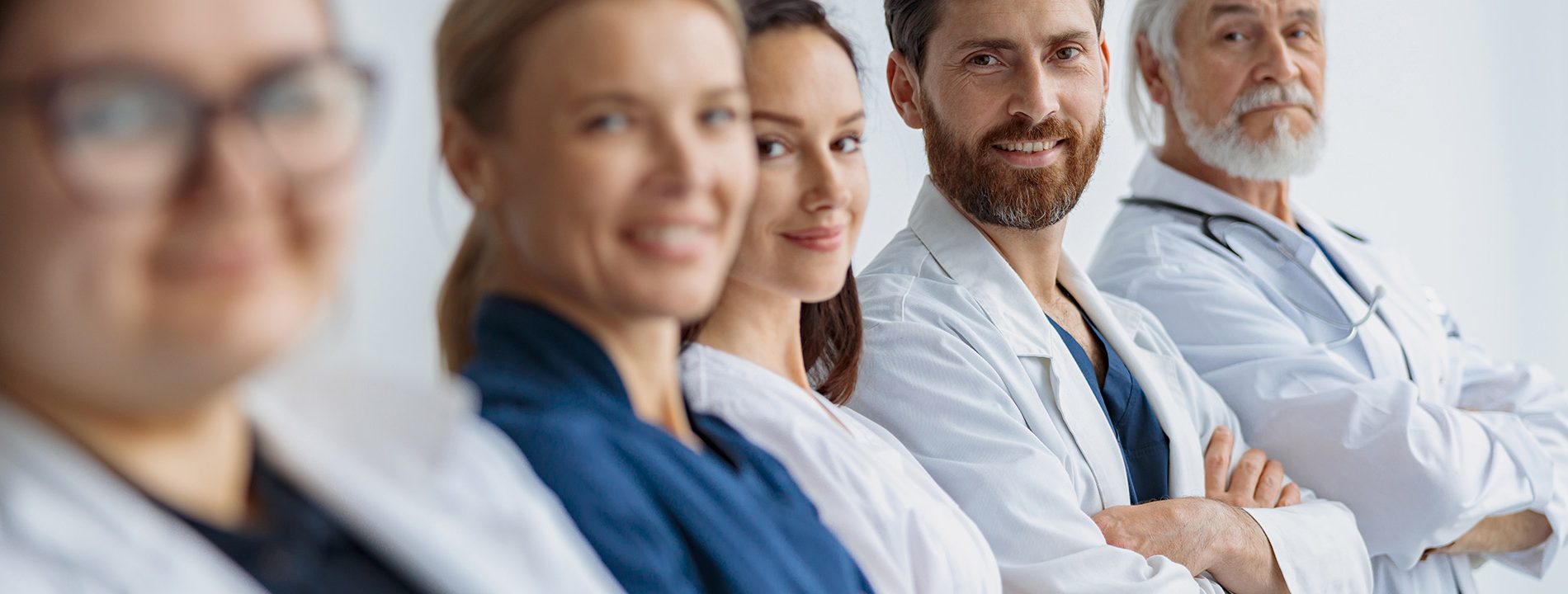 group-of-doctors-standing-in-a-line-keeping-arms